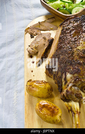 Gigot d'agneau rôti avec des pommes de terre et salade Banque D'Images