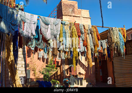 Ballots de laine teints en rose et orange sèche dans les souks de Marrakech Banque D'Images
