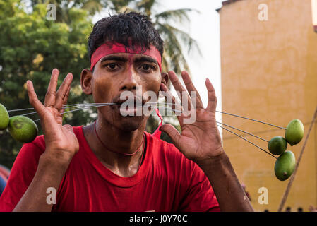 Jeune Indien avec l'homme à travers ses joues brochettes au Bédeille et charak festival en Krishnadepur, West Bengal Banque D'Images