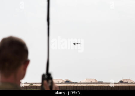 Circuit de l'armée américaine. Joseph Thury, responsable du système d'un véhicule aérien avec la société D, 10e Régiment d'aviation, 10e division de montagne déployées pour Al Asad, l'Iraq, à l'appui de la Force opérationnelle interarmées - Fonctionnement résoudre inhérent, effectue une vérification des communications avec les opérateurs de la SAMU qu'il assure la sécurité de décollage de la MQ-1C Gray Eagle à Al Asad, l'Iraq le 1 avril. Thury effectue plus de 20 vérifications de sécurité avant chaque vol. Les GFIM-OIR est la Coalition mondiale pour vaincre ISIS en Iraq et en Syrie. Banque D'Images