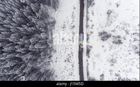 Vue de dessus de l'entretien des rues par un camion chasse-neige dans l'hiver norvégien. Banque D'Images