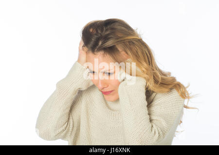 Jeune femme blonde a souligné la tête dans les mains à l'extérieur contre un fond blanc Banque D'Images