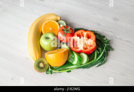 Coeur fait à partir de différents fruits et légumes sur la table en bois clair Banque D'Images