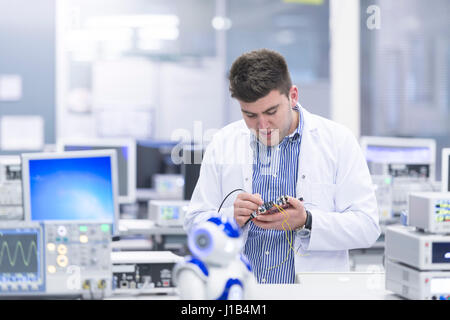 Un laboratoire scientifique avec un scientifique enquête sur l'ingénierie électrique. Banque D'Images