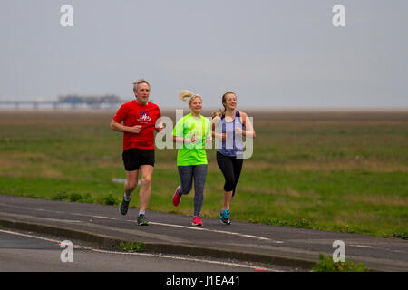 Southport, Lancashire, Royaume-Uni. Météo britannique. 21 avril, 2017. Les coureurs de la famille sur un jour gris, terne. Averses prévues comme tôt le matin, les marcheurs, les joggeurs et les cyclistes prennent de l'exercice dans la station. /AlamyLiveNews MediaWorldImages crédit ; Banque D'Images