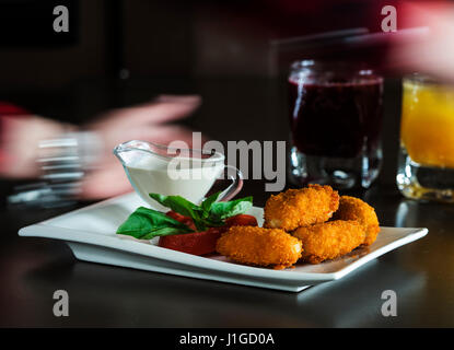 Menu enfant : nuggets de poulet croustillant à la tomate, basilic et à la crème sur une plaque blanche Banque D'Images