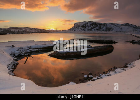 Cimetière de petits bateaux de pêche en Teriberke au lever du soleil. Région de Mourmansk, en Russie. Banque D'Images