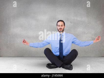 Digital composite of business man meditating dans salle grise Banque D'Images