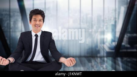 Digital composite of business man meditating contre fenêtre floue bleu foncé Banque D'Images