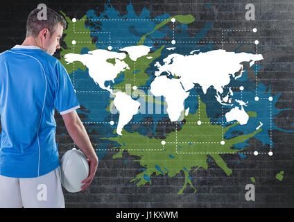 Digital composite de Rugby player holding ball à côté de la carte colorée avec la peinture des éclaboussures sur wall background Banque D'Images