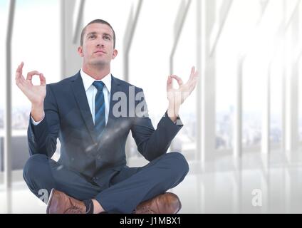 Digital composite de l'homme d'affaires avec flare méditer contre la fenêtre blanche floue Banque D'Images