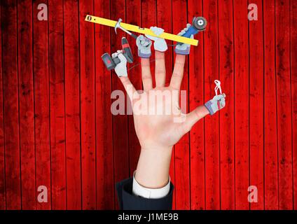 Digital composite de pair avec les mains avec des outils sur les doigts. Fond de bois rouge Banque D'Images