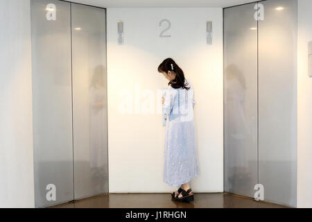 Metal moderne des portes d'ascenseur avec femme dans un hall Banque D'Images