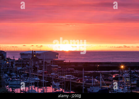L'Angleterre, port de Ramsgate. Lever de soleil sur la manche. Le port de Ramsgate de premier plan. Petite Bande d'open orange ciel avec lever de soleil, au-dessus de ce nuage mauve en couches épaisses. Banque D'Images