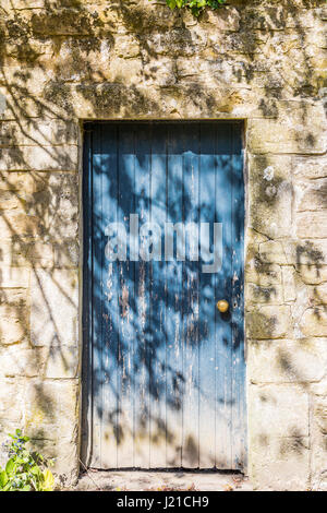 Une vieille porte bleue dans un mur en pierre de Bath en Angleterre, Royaume-Uni Banque D'Images