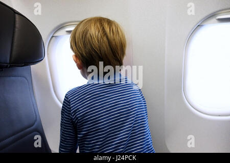 Petit garçon à la fenêtre de l'avion de Banque D'Images