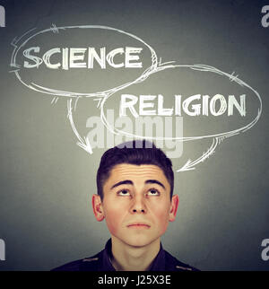 Jeune homme pensif qui composent son esprit la science ou la religion Banque D'Images