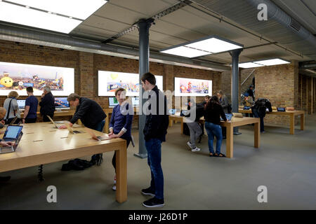 La navigation des clients les produits Apple à l'Apple Store situé sur Covent Garden, Londres, Angleterre, Royaume-Uni, Europe Banque D'Images