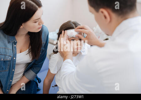 Belle homme médecin mettre un pansement médical Banque D'Images