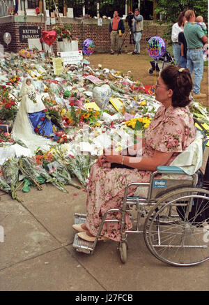 Danette Byrne de Hampstead, MD examine les fleurs et cadeaux laissés en hommage à la princesse Diana lors de l'attente de l'ambassade britannique à Washington, DC pour ouvrir à signer le livre de condoléances de la princesse Diana, le 6 septembre 1997. Danette est propriétaire de la "Princess Diana Bride Doll' vu à gauche et a voulu l'afficher à l'ambassade en hommage à la princesse. La princesse a été tué dans un accident de voiture à Paris, France. Credit : Ron Sachs / CNP - PAS DE SERVICE DE FIL- Photo : Ron Sachs/consolidé Nouvelles Photos/Ron Sachs - CNP Banque D'Images