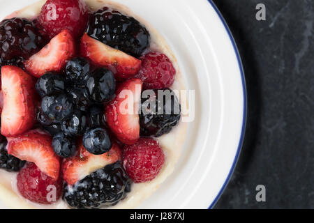Close up de petits fruits surmontée cheesecake dans la plaque de dessus Banque D'Images