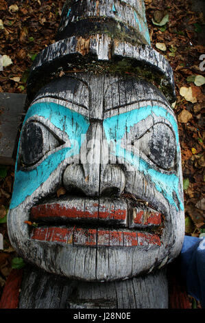 Visage humain sur la sculpture Totem portant sur le terrain, Haines, Alaska Banque D'Images