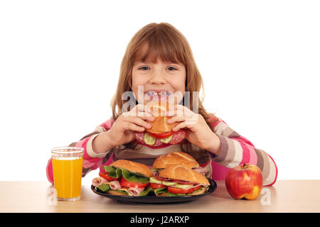 Happy little girl eating sandwich Banque D'Images