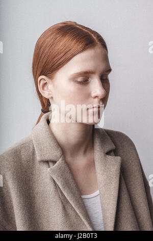 Close-up of woman with eyes closed against white background Banque D'Images