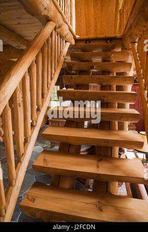 Un escalier en bois menant à la chambre principale à l''étage étage à l'intérieur d'une épinette handcrafted log home Banque D'Images