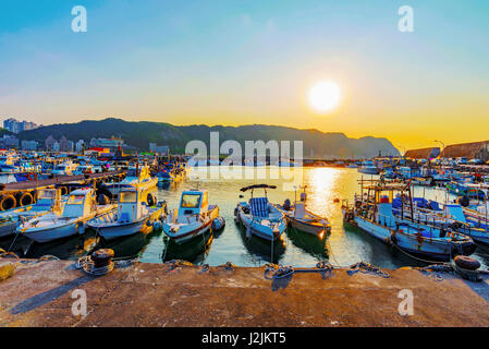 Bateaux à quai dans une petite ville de pêche pendant le coucher du soleil à Taiwan Banque D'Images