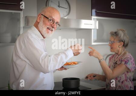 Vieux couple manger dans la cuisine Banque D'Images