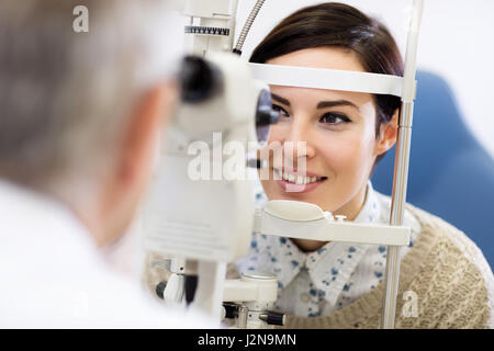 Femme entendre sombre pour déterminer l'ophtalmoscope en clinique en dioptries Banque D'Images