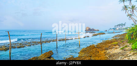 La côte rocheuse, à côté de la Monterey beach est l'endroit parfait pour regarder le paysage marin, profiter de la nature ou de pêche sur pilotis, populaire ici, au Sri Lanka. Banque D'Images