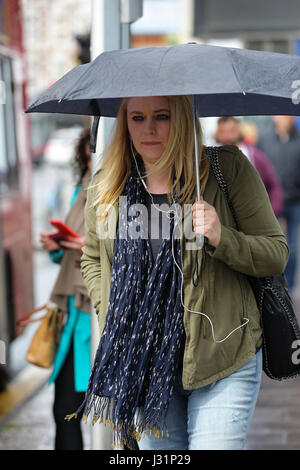 Hornsey, au nord de Londres, au Royaume-Uni. 1er mai 2017. Une femme s'abritant sous des parasols sur un jour pluvieux de Hornsey, au nord de Londres. Credit : Dinendra Haria/Alamy Live News Banque D'Images