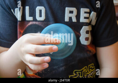 Un jeune garçon évoluant avec un spinner fidget. Banque D'Images