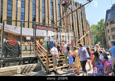 Le Golden Hinde II, Londres, Angleterre, Royaume-Uni. Un guide touristique en robe période accueille les touristes à bord de la réplique de Sir Francis Drake's galleon navire. Banque D'Images