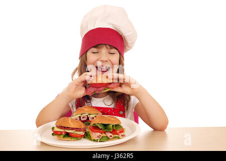 Petite fille affamée cook eating sandwich Banque D'Images