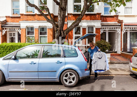 Une mère aide son fils Déménagement, Londres, Angleterre Banque D'Images