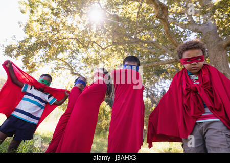 Low angle view of woman wearing superhero costume tandis qu'au camping Banque D'Images