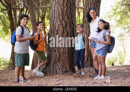 Heureux les élèves et l'enseignant au cours de l'arbre de sortie de classe Banque D'Images