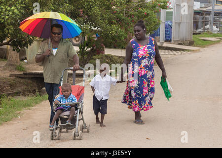 Gizo, Solomon Island - Mars 11th, 2017:famille mélanésienne, marcher dans la rue principale de Gizo port. Banque D'Images