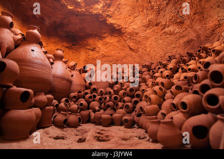 La main pleine de pots et plats . Atelier de poterie Banque D'Images