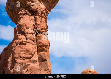 Rock climber sur Pinnacle dans Arches National Park, Utah Banque D'Images