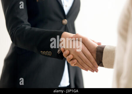 Businessman and businesswoman shaking hands, business handshake Banque D'Images