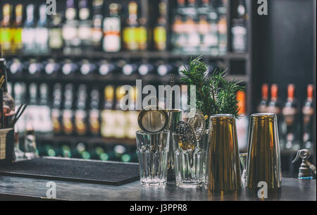 Comptoir de bar classique avec des bouteilles à l'arrière-plan flou Banque D'Images