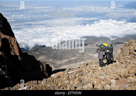 Deux porteurs au-dessus des nuages l'ascension de la violation de l'Ouest, Parc national du Kilimandjaro, Tanzanie Banque D'Images