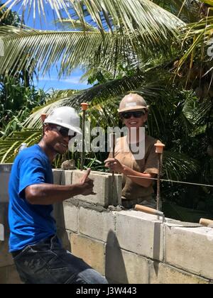 KOSRAE (États fédérés de Micronésie (24 avril 2017) Constructionman , Giebler Angelie Constructeur de Abington, Massachusetts, et de construction locale George Mac apprenti préparer le dernier bloc d'unités de maçonnerie de béton pour la construction navale (bataillon Mobile NMCB) 1 Projet de clinique de santé Walung à Kosrae Micronésie, États fédérés de, 24 avril 2017. 1 NMCB est déployée avant d'exécuter la construction, l'aide humanitaire et l'aide étrangère, les opérations spéciales des services de soutien au combat, et le théâtre à l'appui de la coopération de sécurité américaines du Pacifique. (U.S. Photo par Utilitiesman marine Banque D'Images