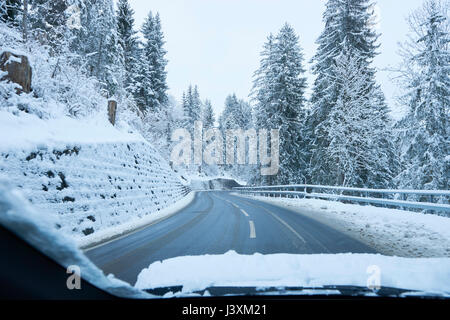 Vue de pare-brise et de routes rurales de la forêt enneigée, Gstaad, Suisse Banque D'Images