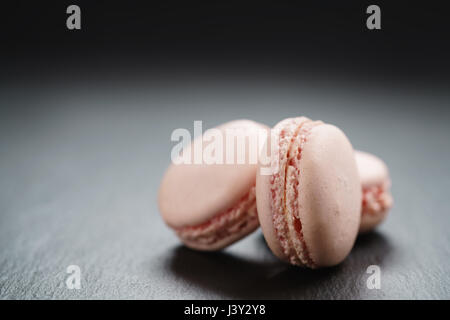 Macarons rose clair sur fond ardoise with copy space Banque D'Images