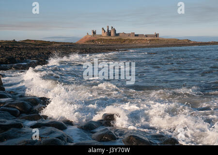 Château de Dunstanburgh sur son seuil rocheux, vu Whin venant du sud. Le château, construit au 14ème siècle, est tombé en ruine par le 16ème siècle. Banque D'Images